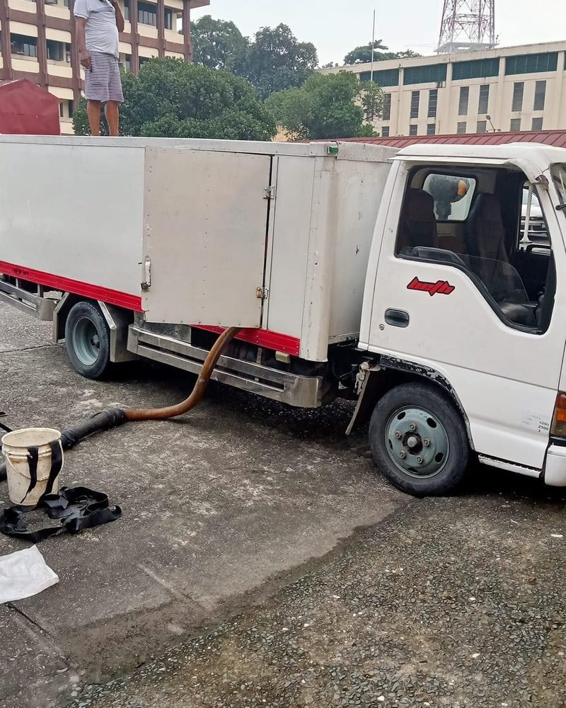 Siphoning truck connected to a septic line