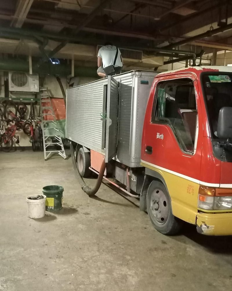 Siphoning truck parked with hose connected